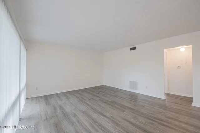 a view of a kitchen with a sink and wooden floor