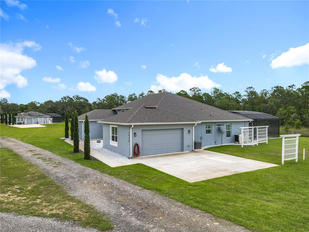 10220 Bay Lake Road Groveland, FL 34736 - Photo 7 of 67 a view of a house with a big yard
