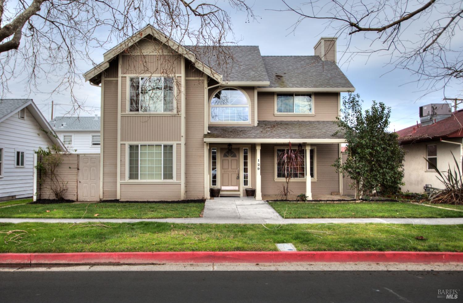 129 North 5th Street Rio Vista, CA 94571 - Photo 1 of 1 a front view of a house with a yard and garage