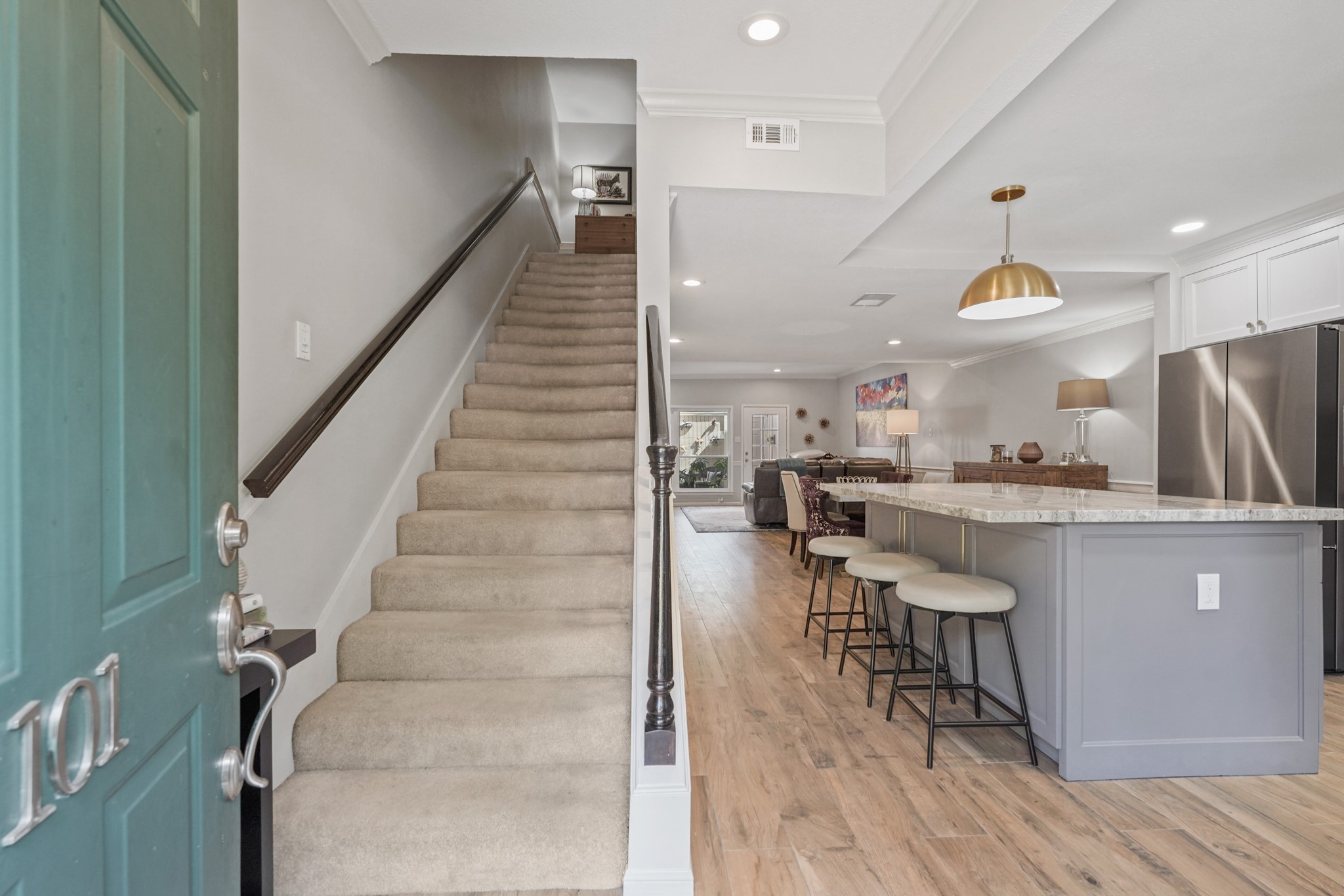 2236 South Piney Point Road, Unit 101 Houston, TX 77063 - Photo 3 of 21 You'll be instantly greeted by beautiful wood look tile floors, a charming stair case, and a view straight back into the living room.