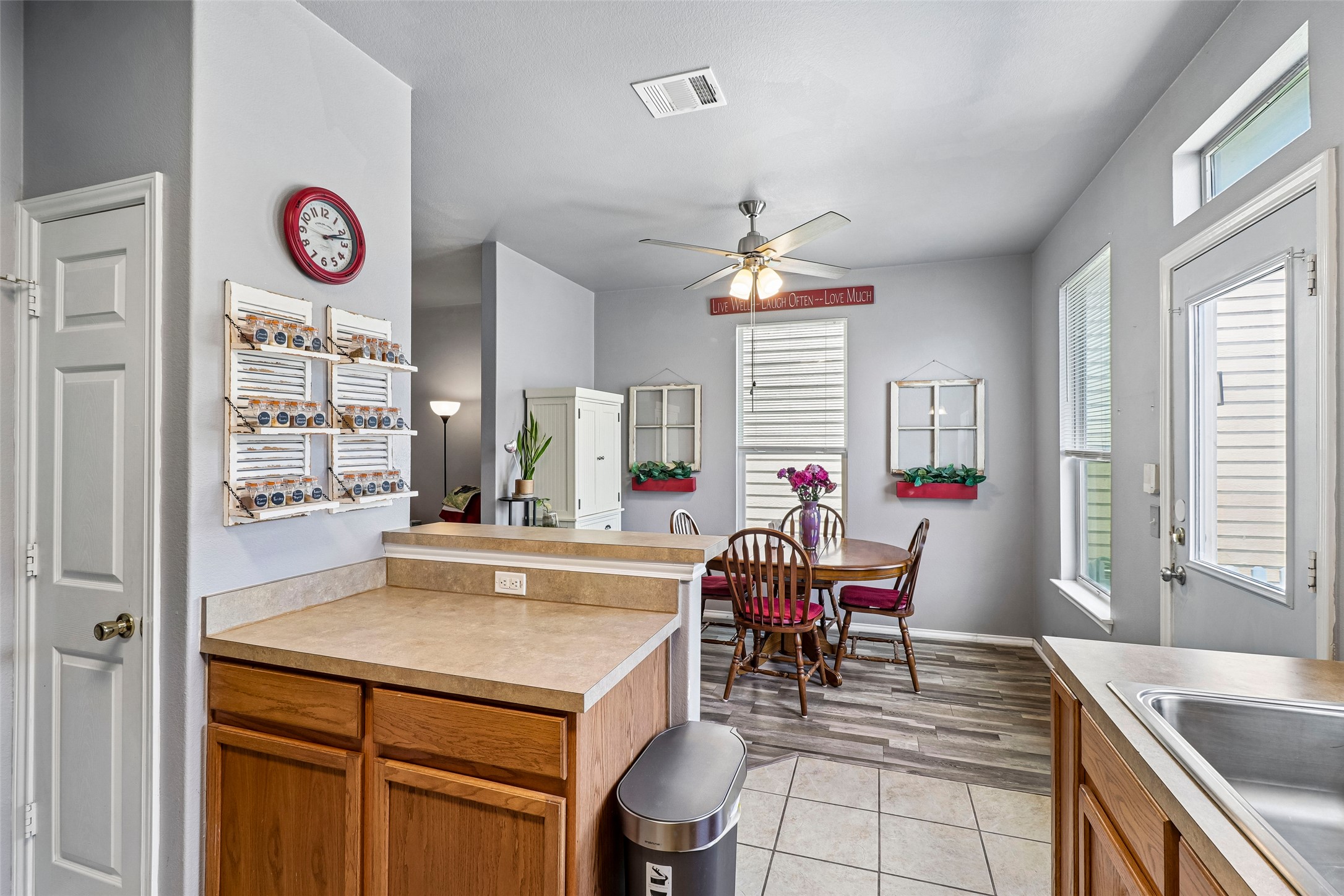 311 A Utterback Kyle, TX 78640 - Photo 15 of 40 a view of a kitchen with granite countertop a dining table chairs and a chandelier