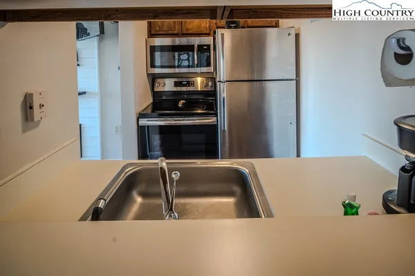 a kitchen with a refrigerator and a sink