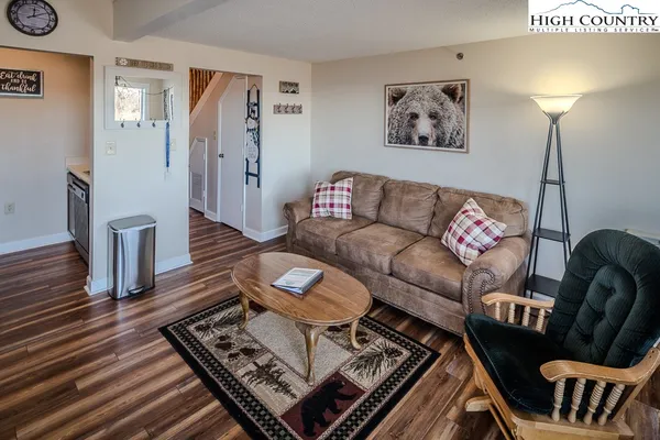 a living room with furniture and a wooden floor
