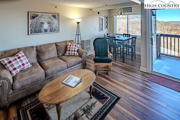 a living room with furniture and wooden floor