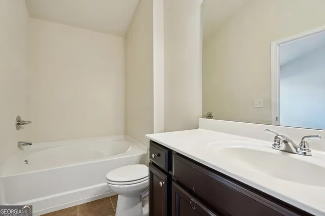 a bathroom with a sink a toilet and bathtub