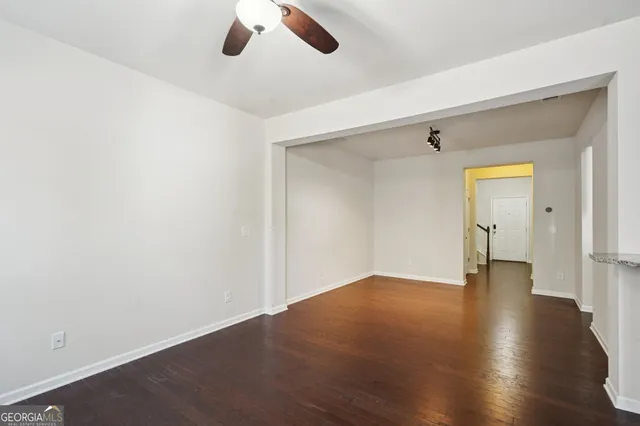 a view of an empty room with wooden floor