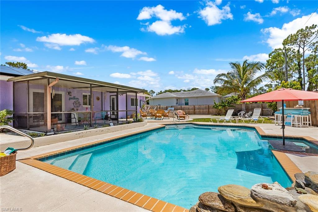 9208 Hamlin Road East Fort Myers, FL 33967 - Photo 10 of 31 View of swimming pool featuring stone waterfall
