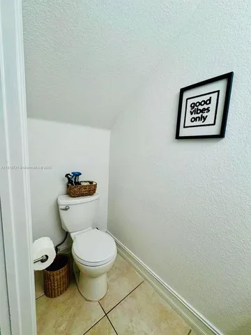 a white toilet sitting next to a small bathroom