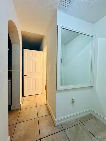 a view of an empty room with a bathroom