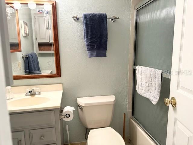 7701 Starkey Road, Unit 731 Seminole, FL 33777 - Photo 7 of 19 a bathroom with a toilet sink vanity and mirror