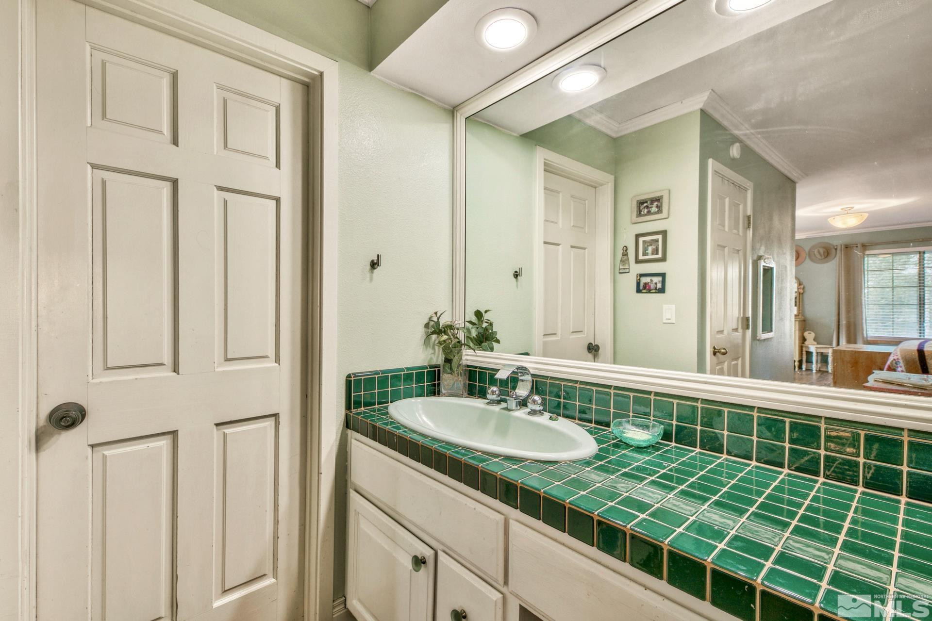 1980 Emigrant Trail Woodfords, CA 96120 - Photo 27 of 40 a bathroom with a sink double vanity and a mirror