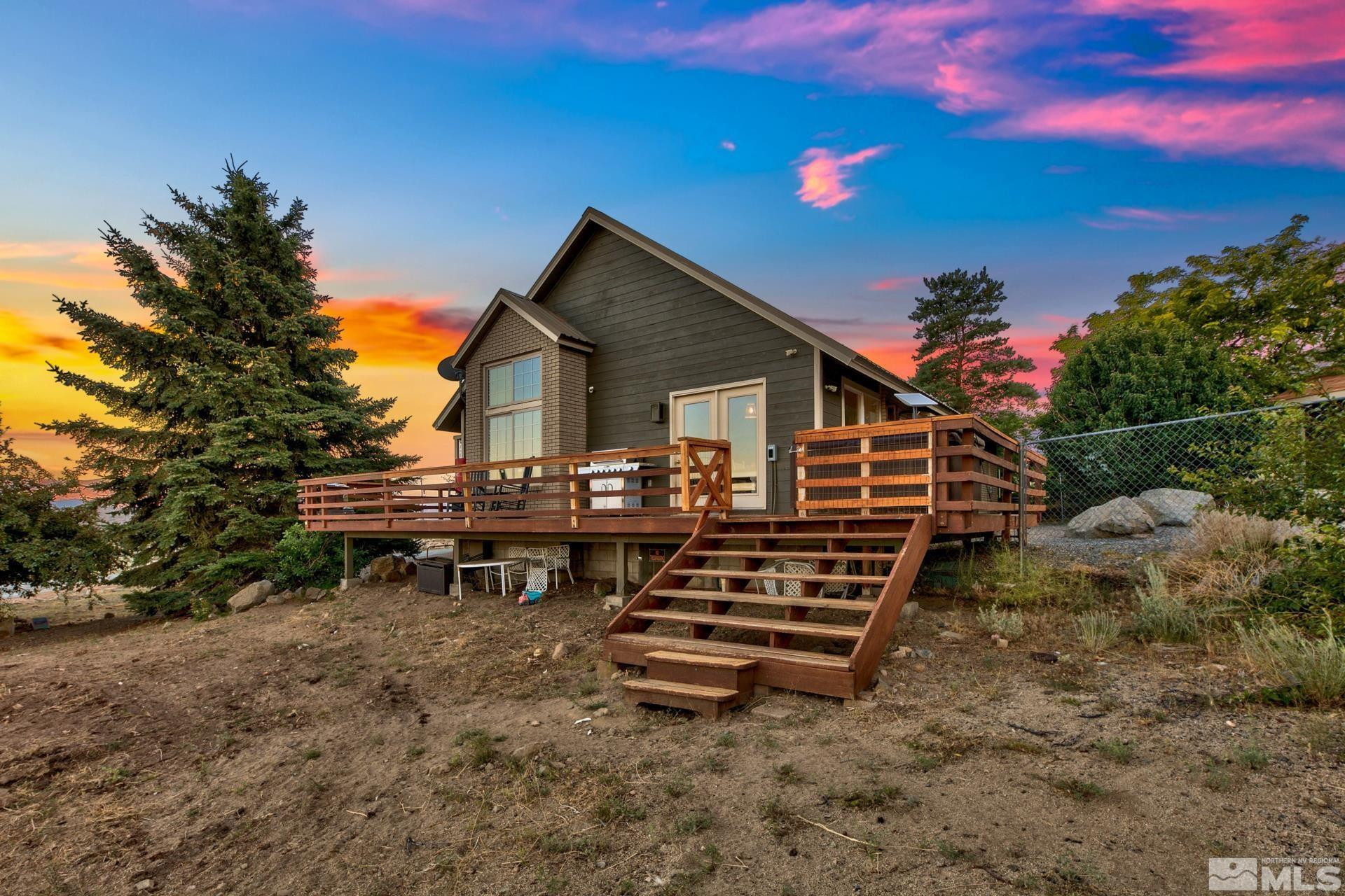 1980 Emigrant Trail Woodfords, CA 96120 - Photo 6 of 40 a backyard of a house with wooden deck and outdoor seating