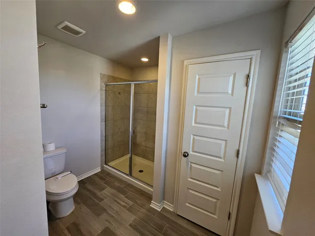 a bathroom with a toilet a sink and shower