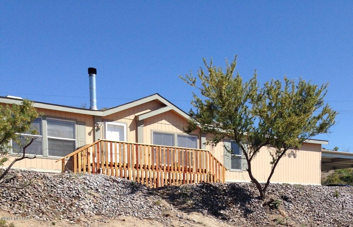 15146 North Ironwood Tree Road Tucson, AZ 85739 - Photo 1 of 9 a view of a house with a small yard and wooden fence