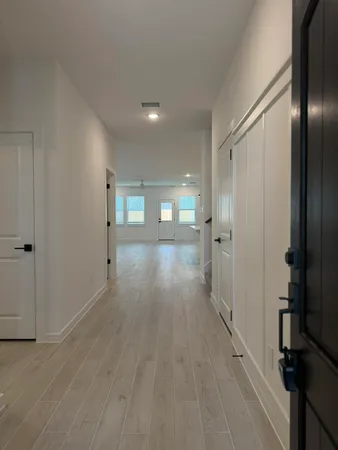 a view of a hallway with wooden floor
