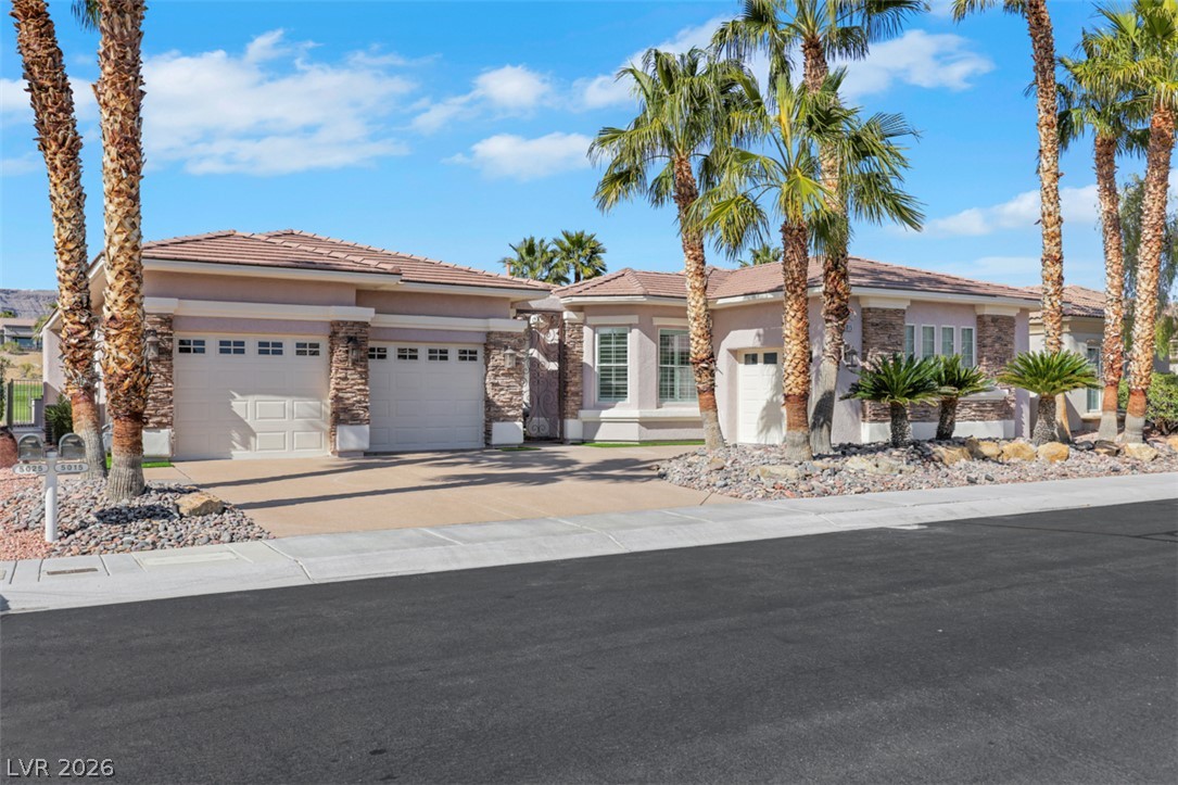 5015 Rivedro Street Las Vegas, NV 89135 - Photo 6 of 91 Two garages and an inviting driveway define this attractive suburban residence.
