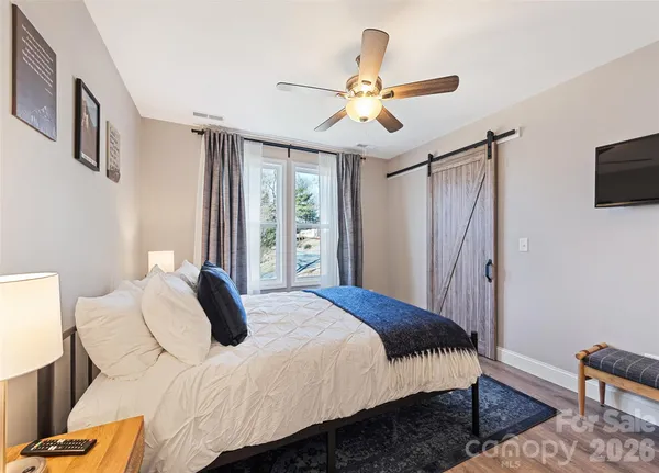 a bedroom with a bed dresser and a window