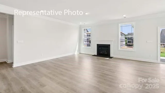 a view of a livingroom with wooden floor and a ceiling fan