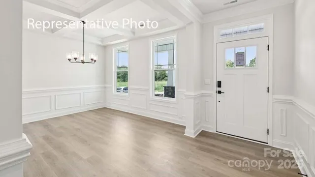 a view of an entryway with wooden floor
