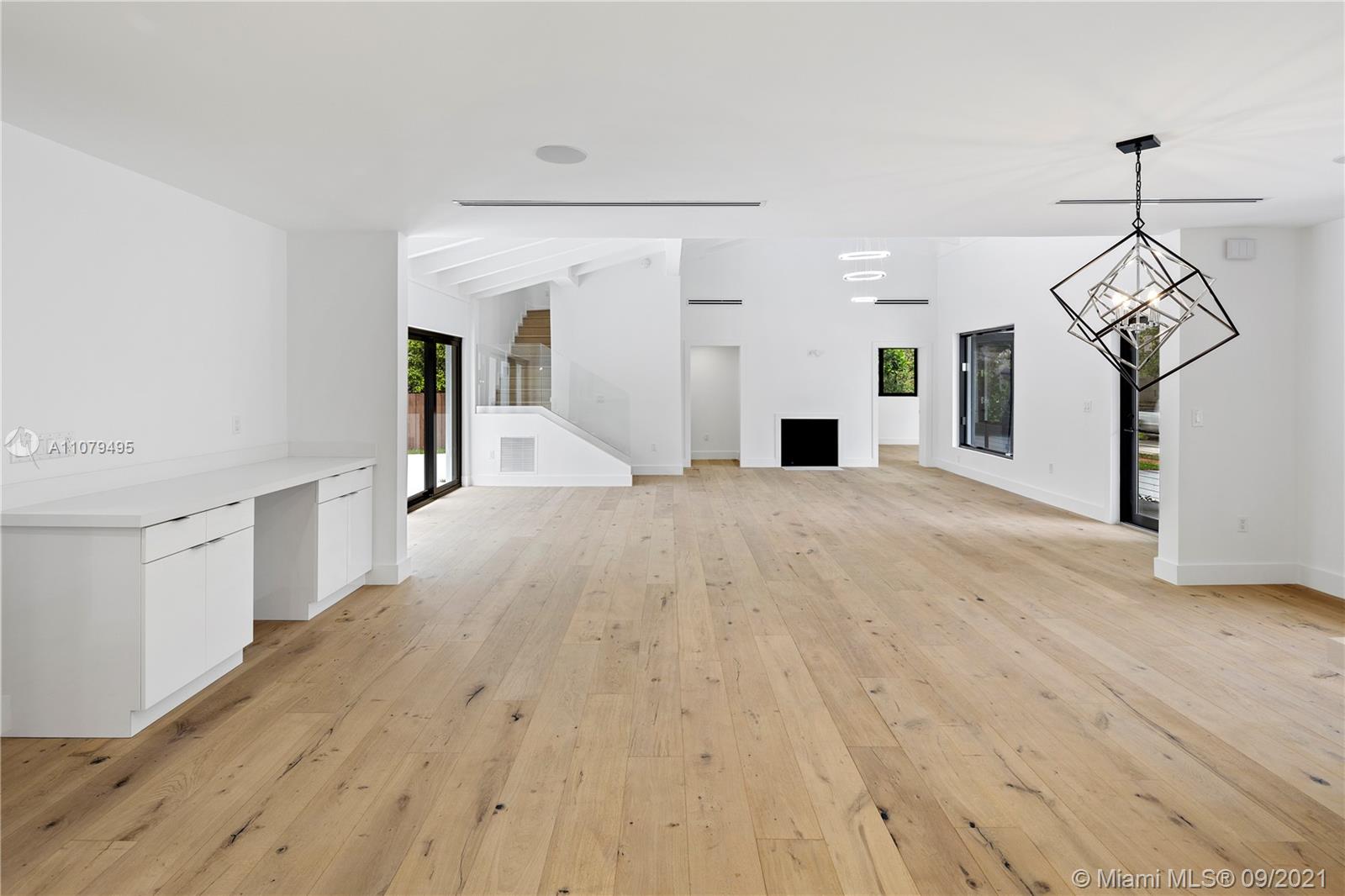 4450 Alton Road Miami Beach, FL 33140 - Photo 12 of 35 a view of a kitchen with wooden floor and a sink