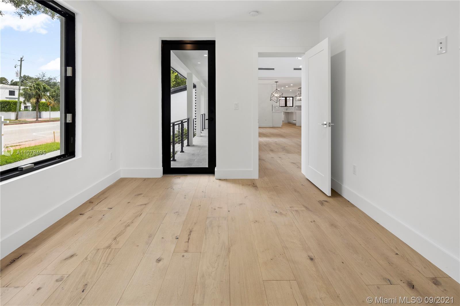 4450 Alton Road Miami Beach, FL 33140 - Photo 17 of 35 an empty room with windows and entrance