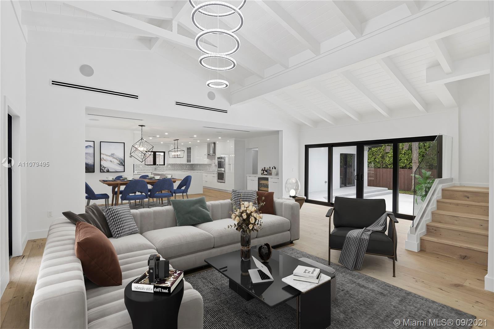 4450 Alton Road Miami Beach, FL 33140 - Photo 3 of 35 a living room with furniture and a large window