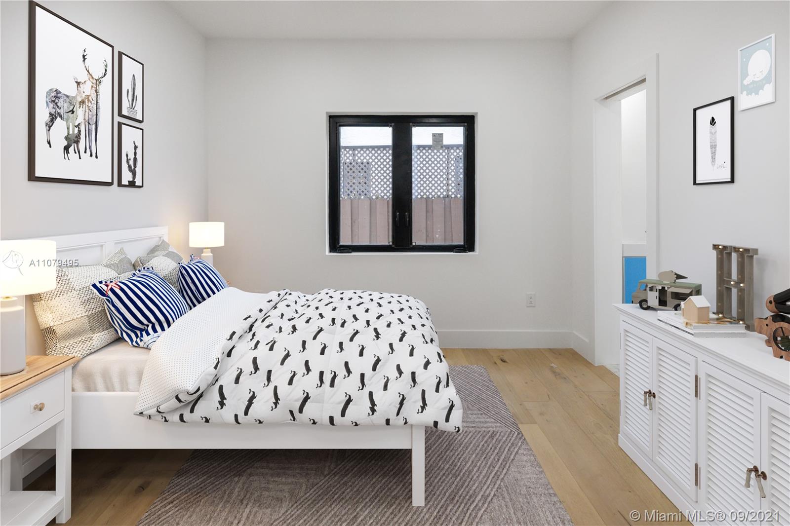 4450 Alton Road Miami Beach, FL 33140 - Photo 22 of 35 a bedroom with a bed and a window