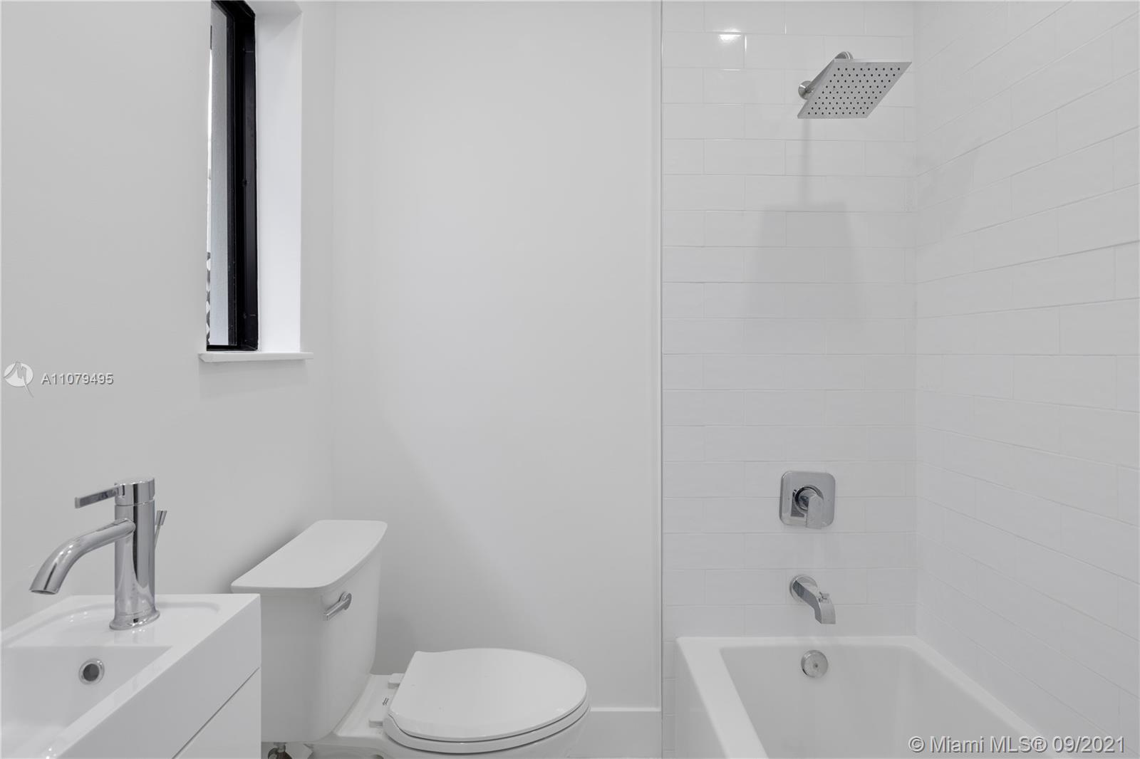 4450 Alton Road Miami Beach, FL 33140 - Photo 23 of 35 a white toilet sitting next to a bath tub