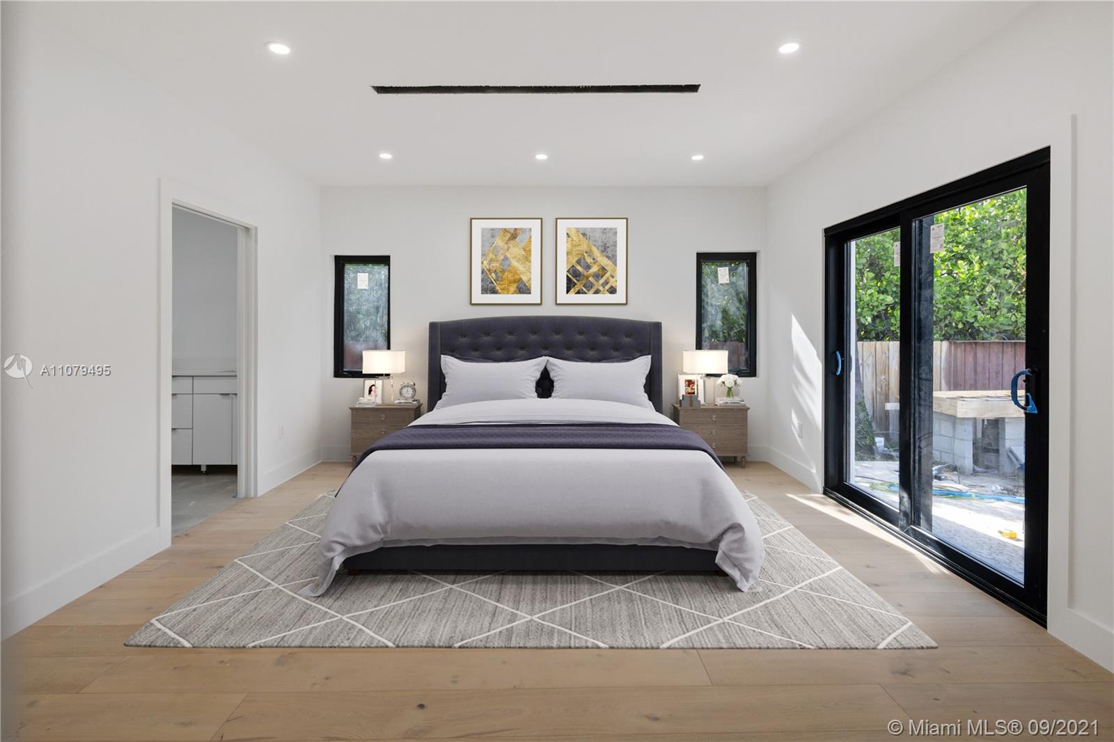 4450 Alton Road Miami Beach, FL 33140 - Photo 24 of 35 a bedroom with a bed and large window