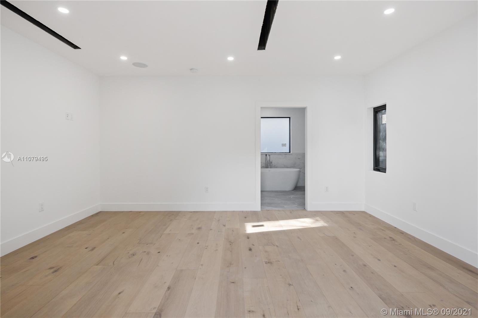 4450 Alton Road Miami Beach, FL 33140 - Photo 26 of 35 an empty room with ceiling fan and window