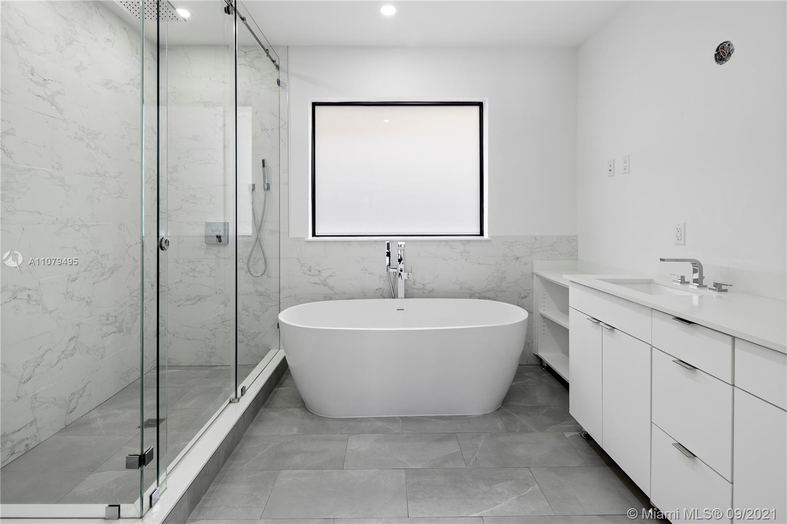 4450 Alton Road Miami Beach, FL 33140 - Photo 27 of 35 a spacious bathroom with a bathtub and shower