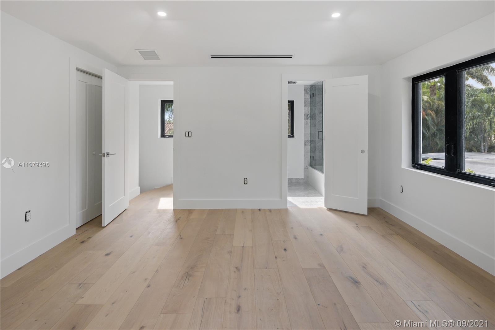 4450 Alton Road Miami Beach, FL 33140 - Photo 29 of 35 a view of an empty room with window and wooden floor