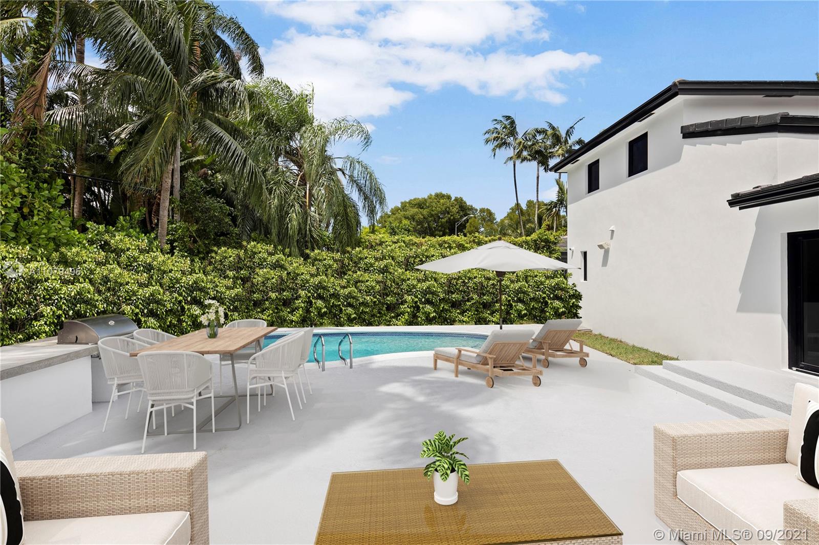 4450 Alton Road Miami Beach, FL 33140 - Photo 31 of 35 a view of a patio with table and chairs and potted plants