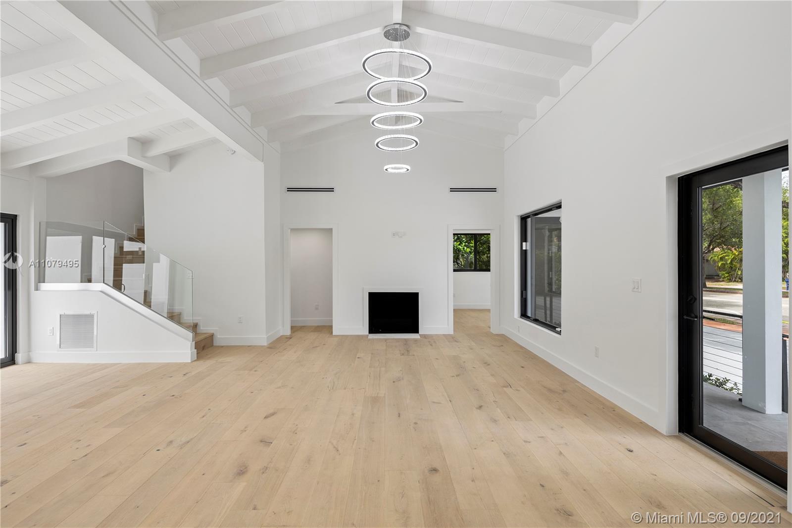 4450 Alton Road Miami Beach, FL 33140 - Photo 6 of 35 a view of a livingroom with a ceiling fan window and hardwood
