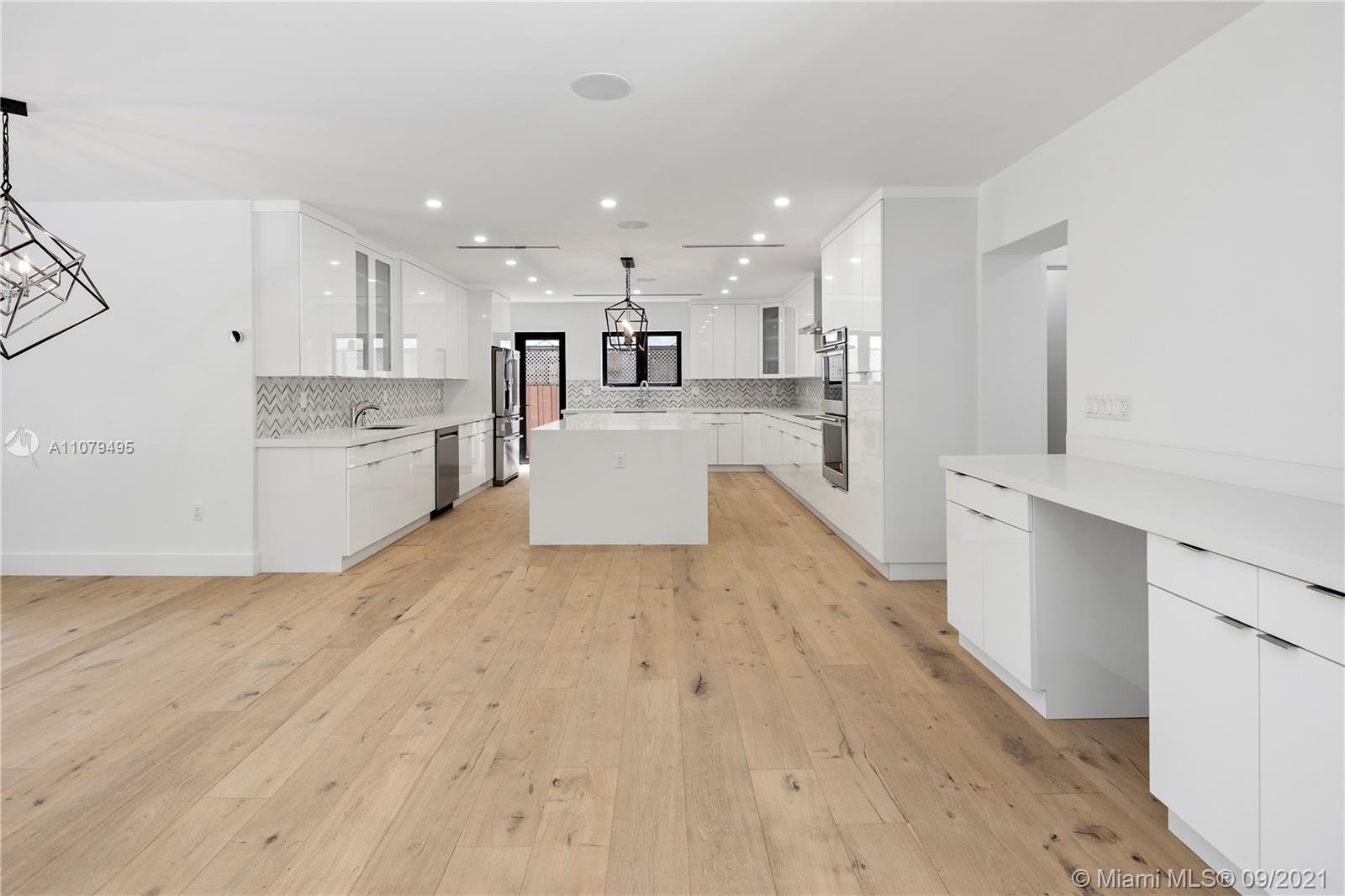 4450 Alton Road Miami Beach, FL 33140 - Photo 9 of 35 a large kitchen with a lot of counter space and appliances