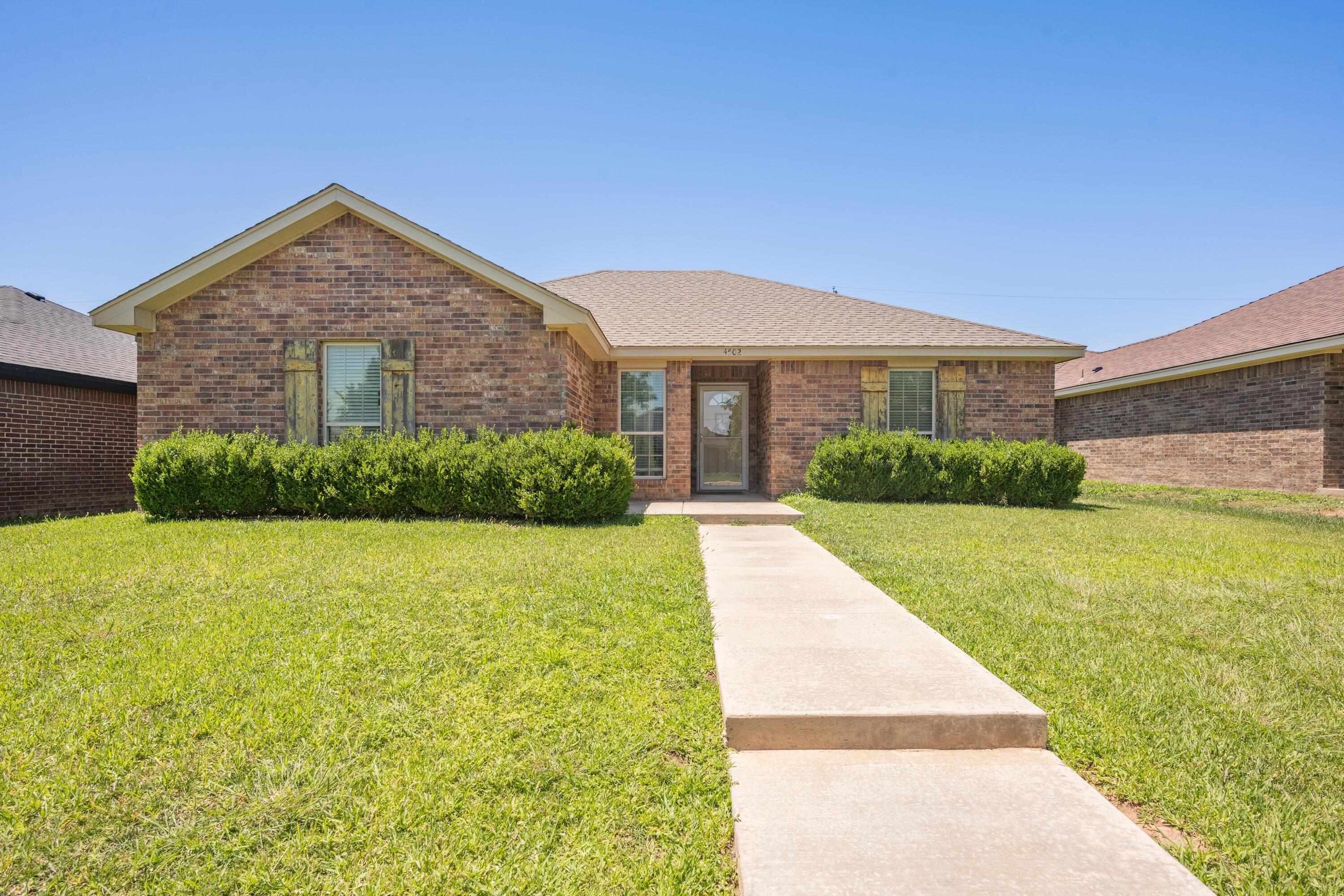 4502 Pine Street Amarillo, TX 79118 - Photo 1 of 20 a view of a house with a yard