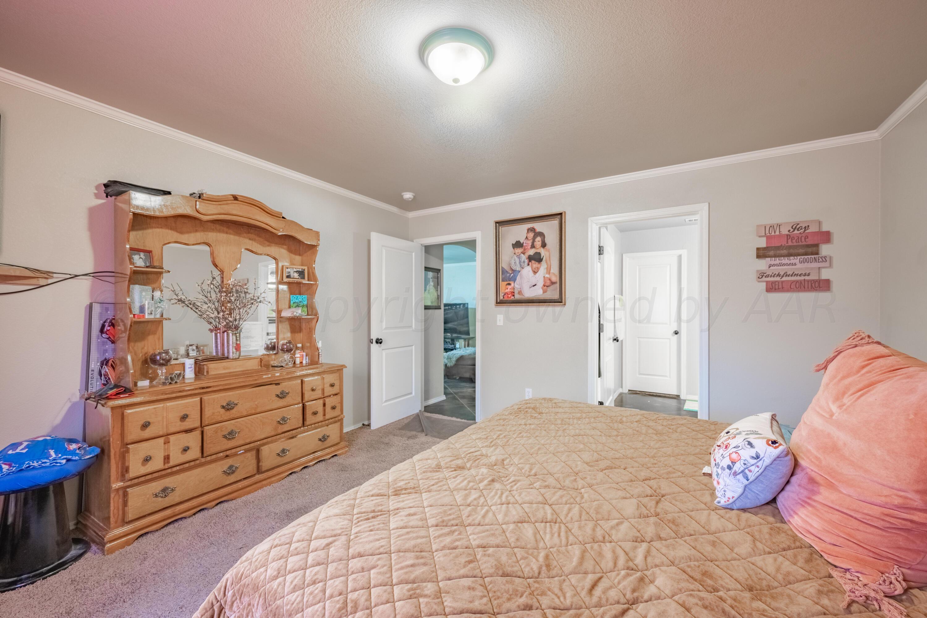 4502 Pine Street Amarillo, TX 79118 - Photo 11 of 20 a bedroom with a bed and a dresser