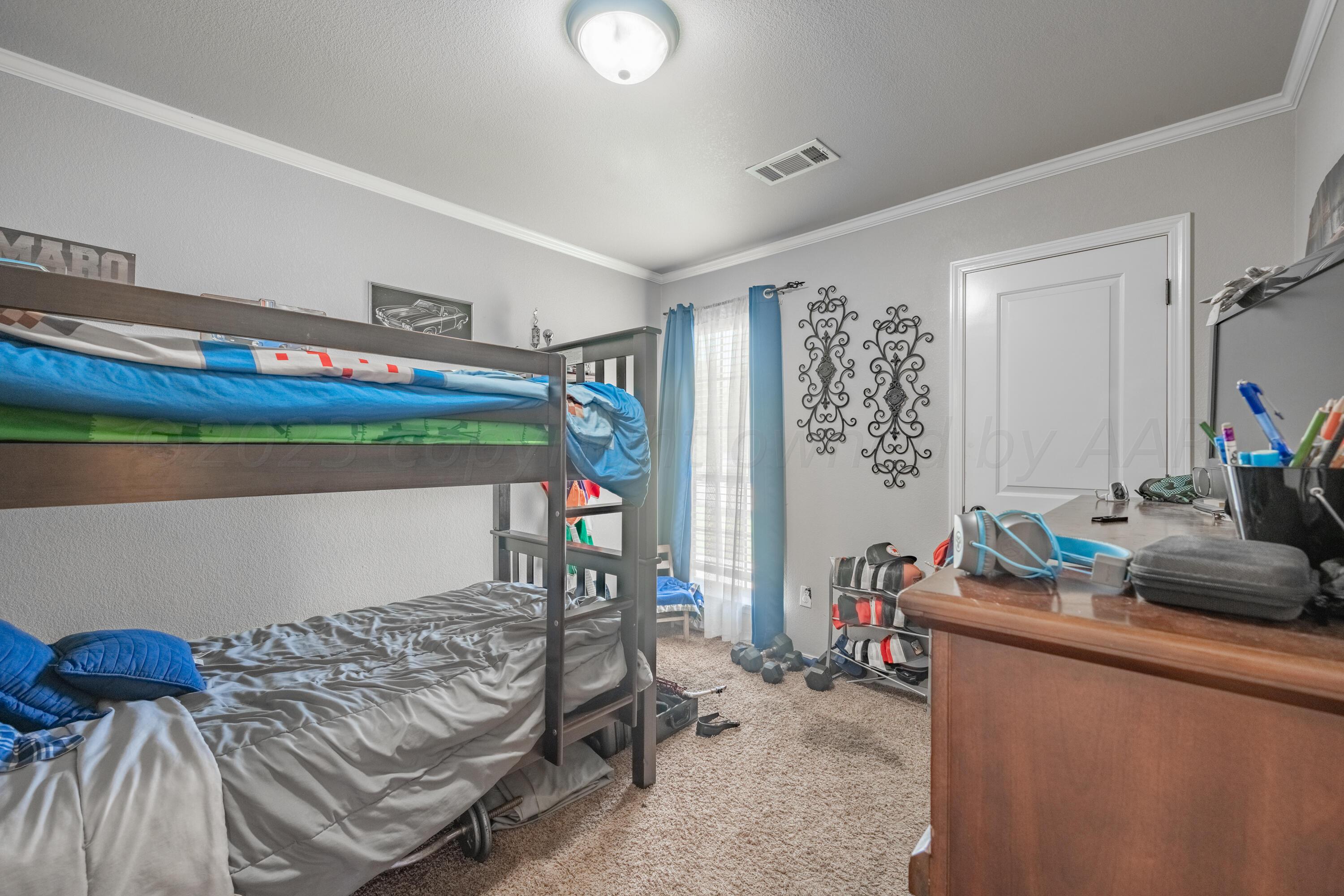 4502 Pine Street Amarillo, TX 79118 - Photo 13 of 20 a bedroom with furniture and a bed