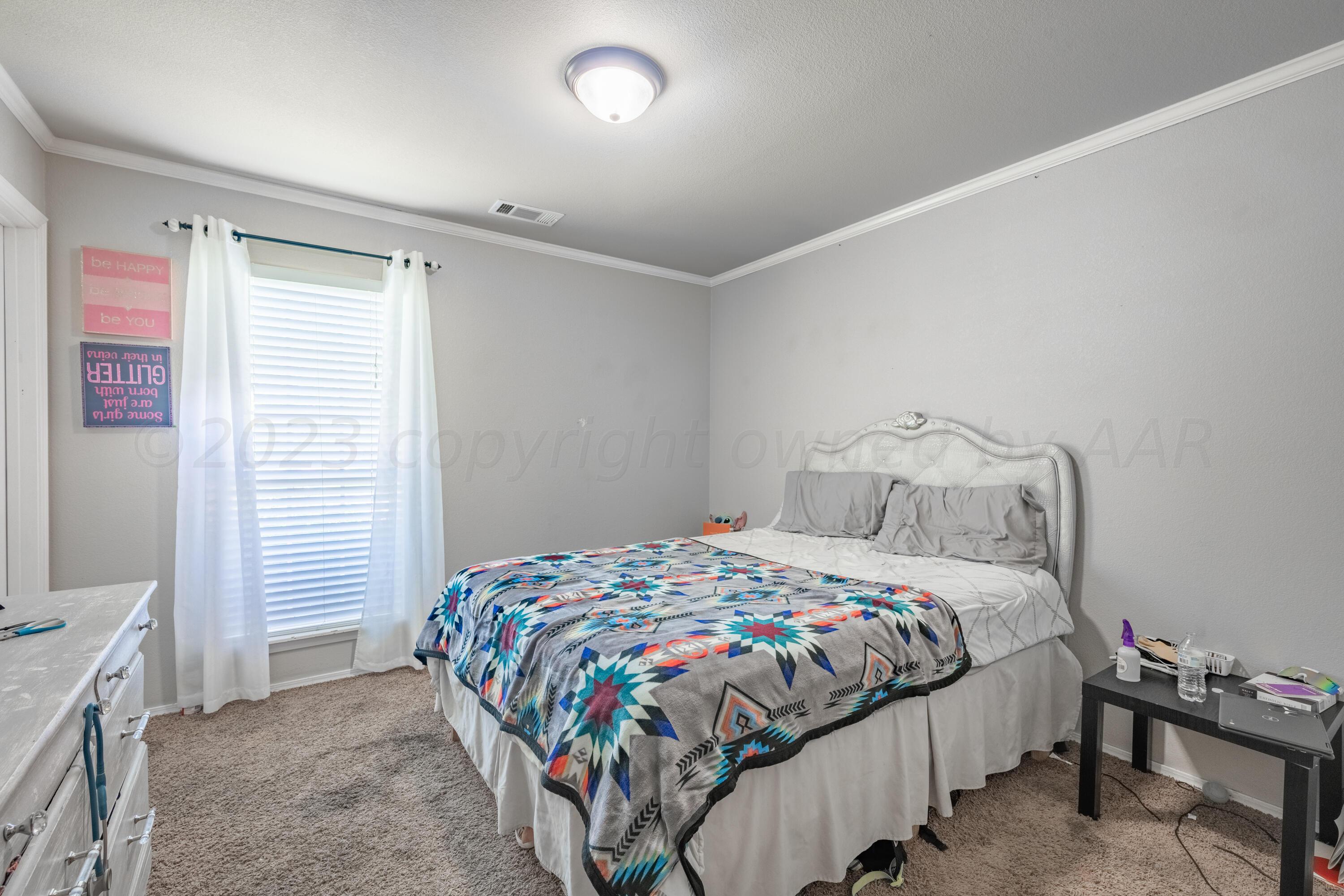 4502 Pine Street Amarillo, TX 79118 - Photo 15 of 20 a bedroom with a bed and a window