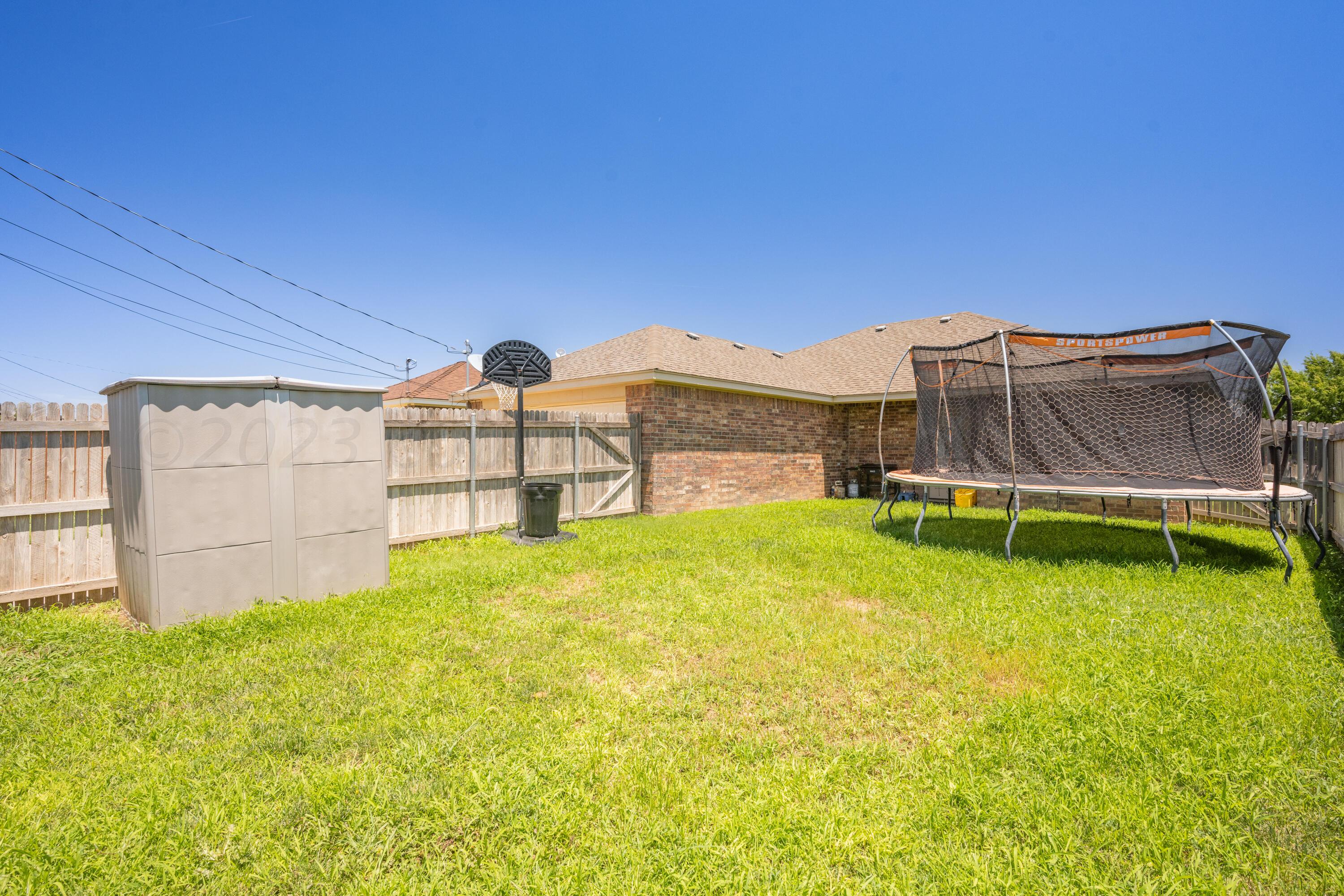4502 Pine Street Amarillo, TX 79118 - Photo 20 of 20 a view of a backyard with a garden and stairs