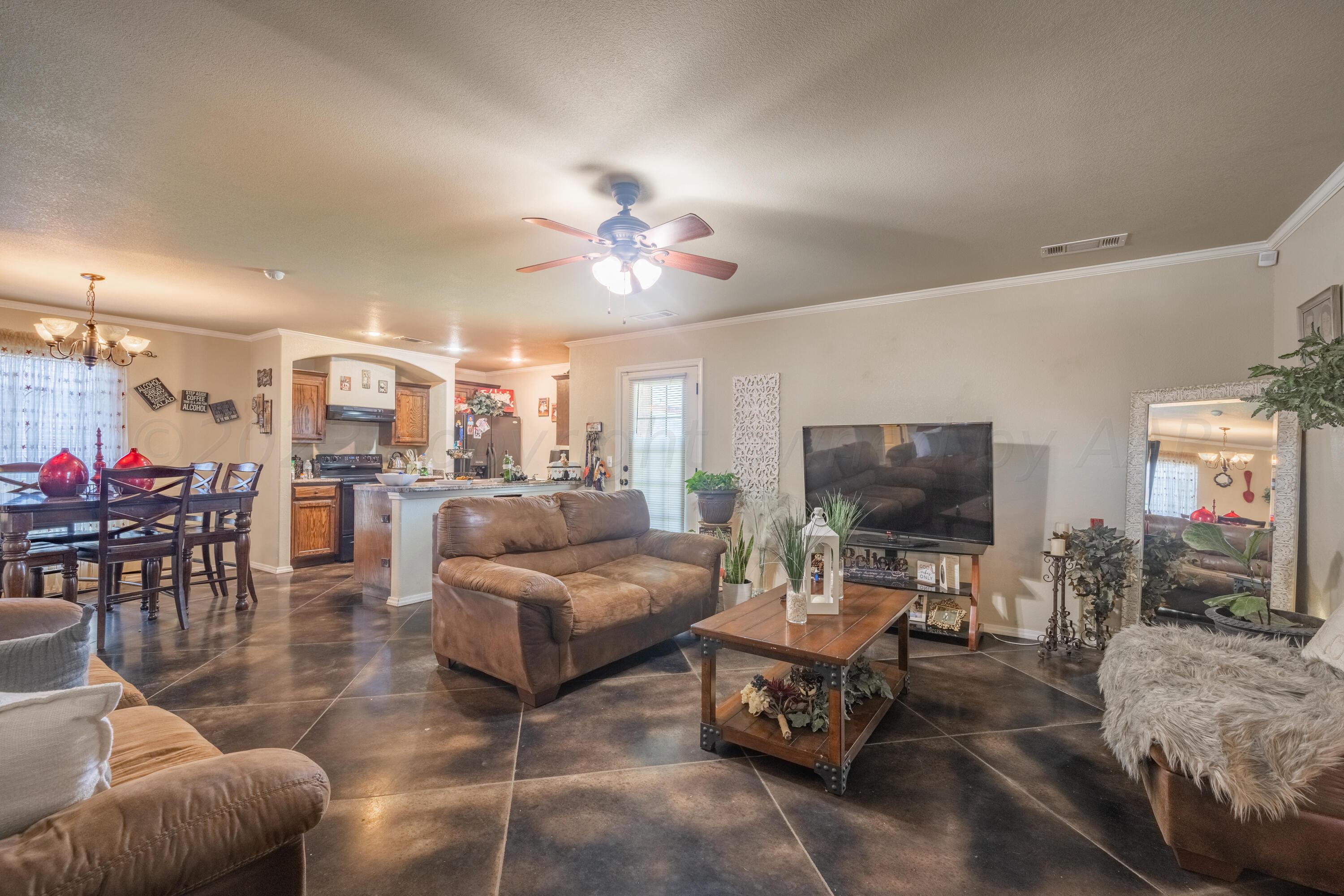 4502 Pine Street Amarillo, TX 79118 - Photo 4 of 20 a living room with furniture and a flat screen tv