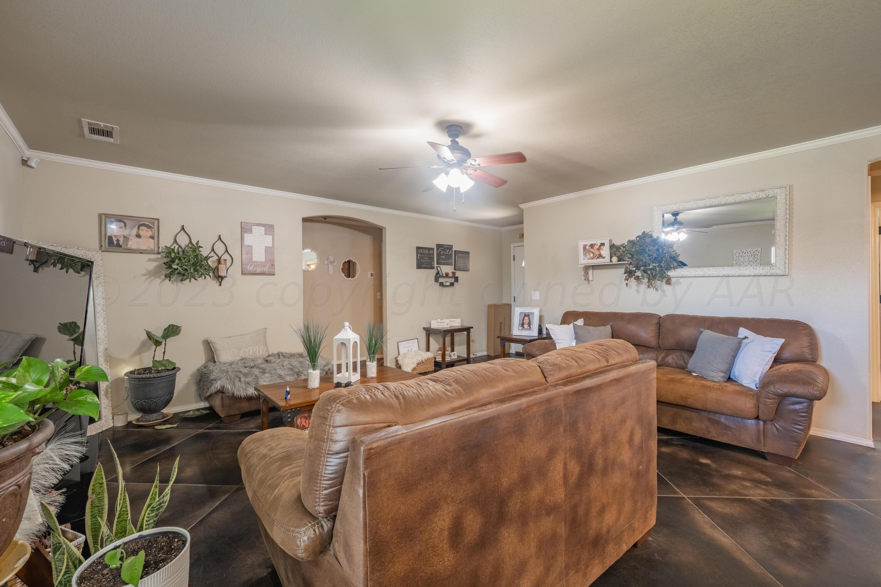 4502 Pine Street Amarillo, TX 79118 - Photo 5 of 20 a living room with furniture potted plant and a lamp