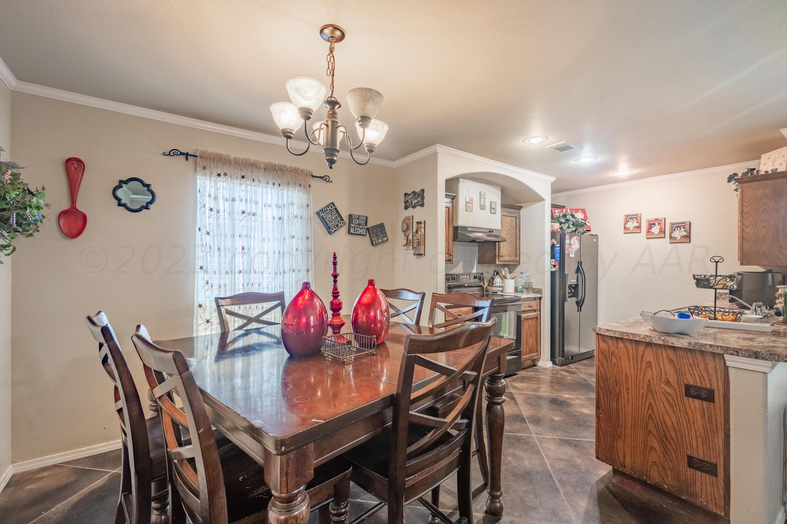 4502 Pine Street Amarillo, TX 79118 - Photo 6 of 20 a view of a dining room with furniture and chandelier