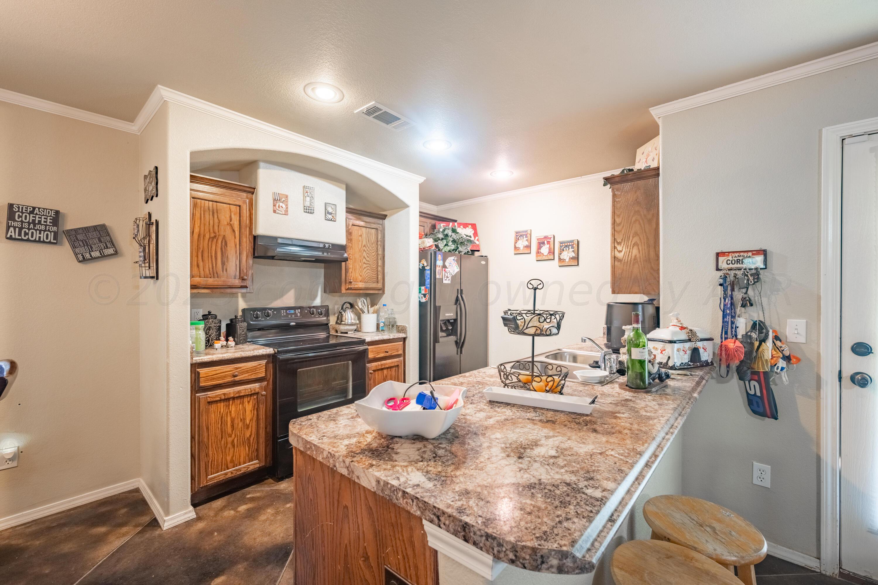 4502 Pine Street Amarillo, TX 79118 - Photo 7 of 20 a kitchen with stainless steel appliances granite countertop a sink stove and refrigerator