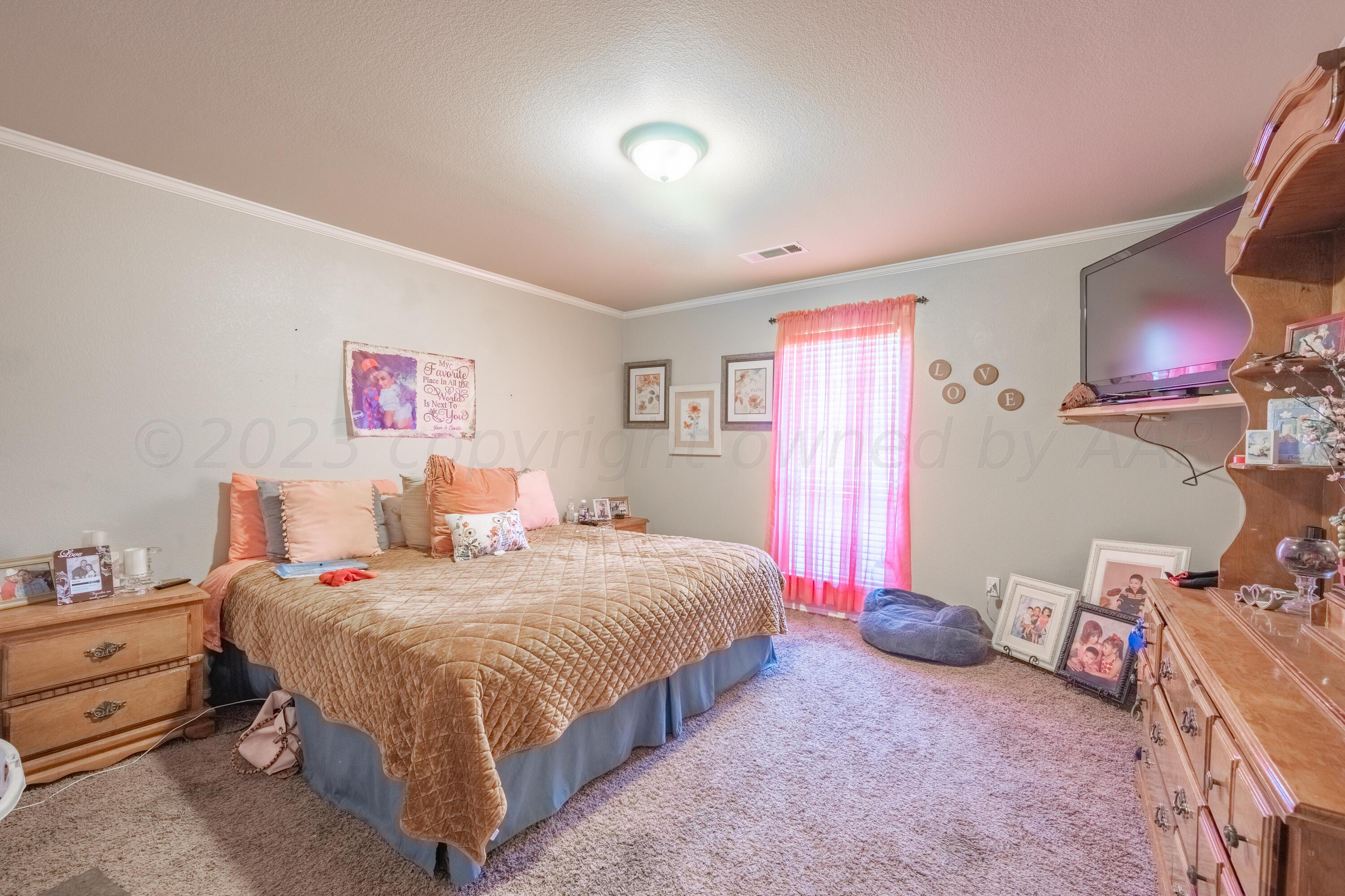 4502 Pine Street Amarillo, TX 79118 - Photo 10 of 20 a bedroom with a bed and a lamp with window