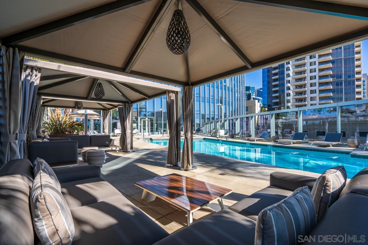 888 E Street, Unit 3502 San Diego, CA 92101 - Photo 24 of 35 a view of a patio with a dining table and chairs under an umbrella