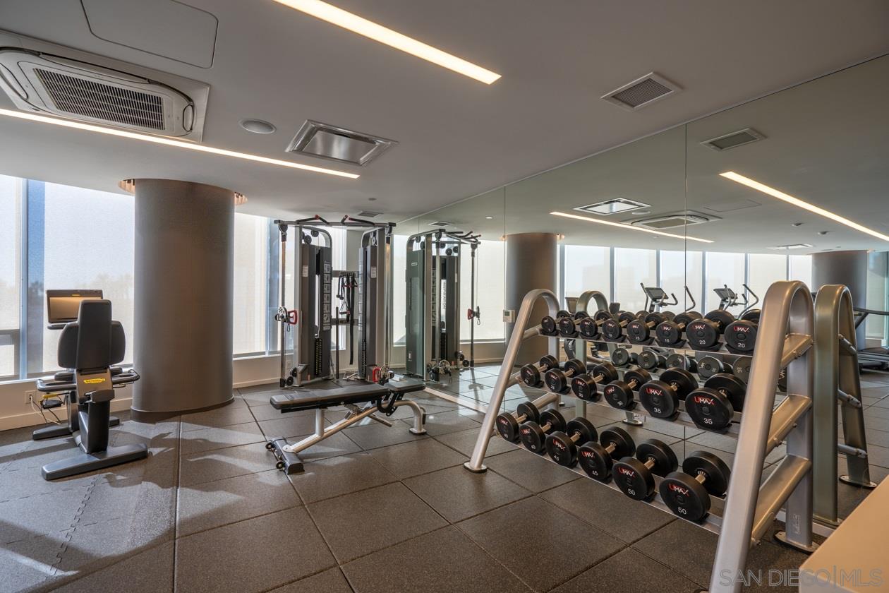 888 E Street, Unit 3502 San Diego, CA 92101 - Photo 32 of 35 a room with gym equipment and a large window