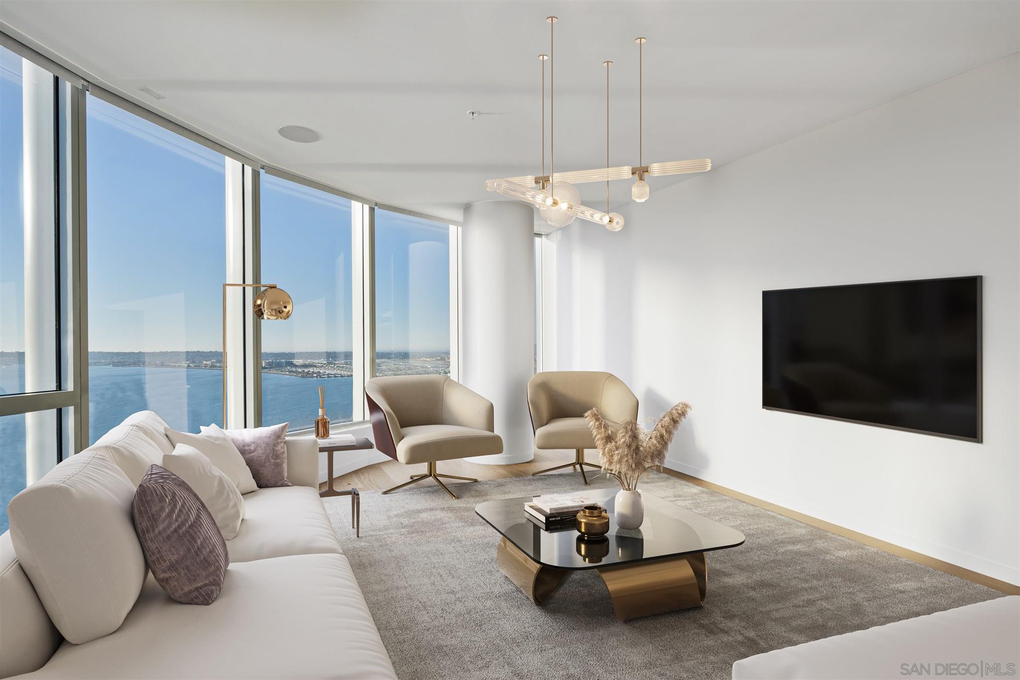 888 E Street, Unit 3502 San Diego, CA 92101 - Photo 4 of 35 a living room with furniture a flat screen tv and a large window