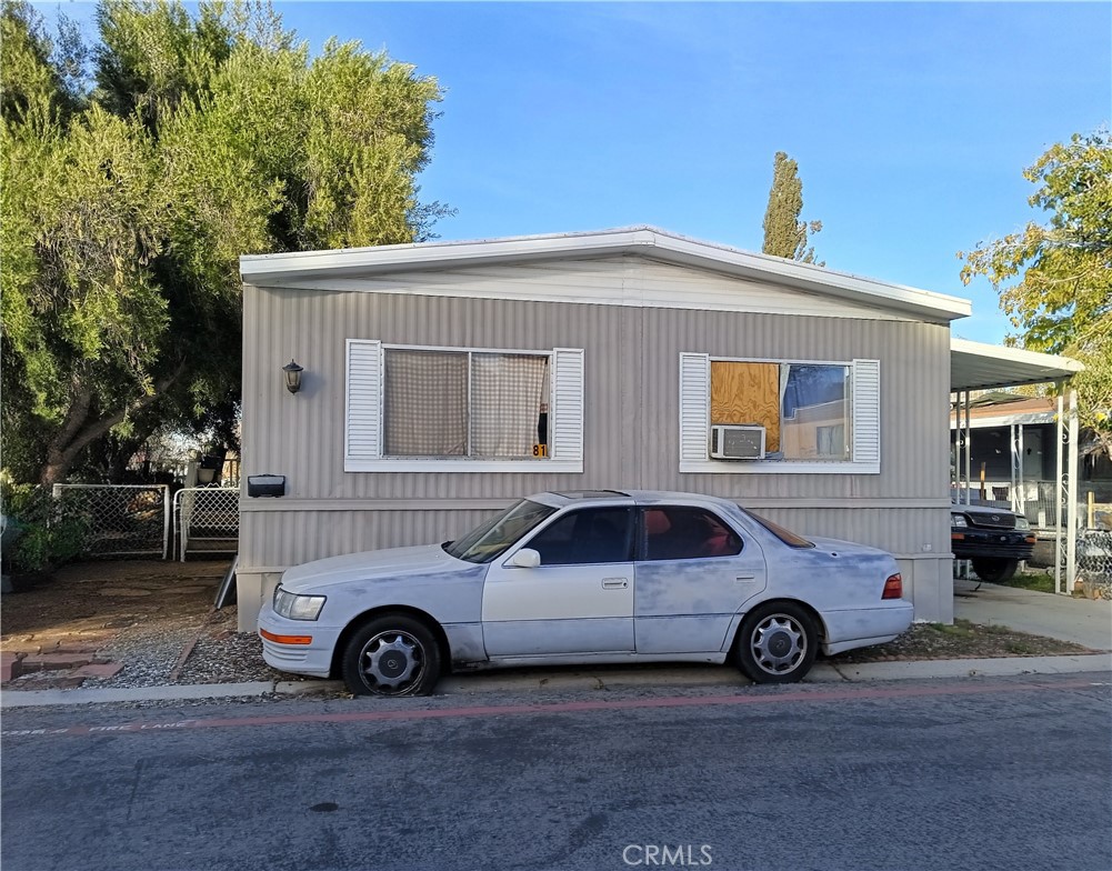 1000 Windy Pass, Unit 81 Barstow, CA 92311 - Photo 1 of 3 a car parked in front of a house