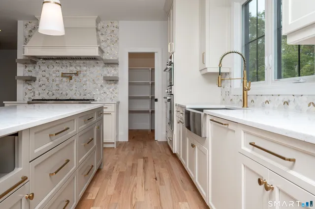 a kitchen with cabinets a sink and appliances